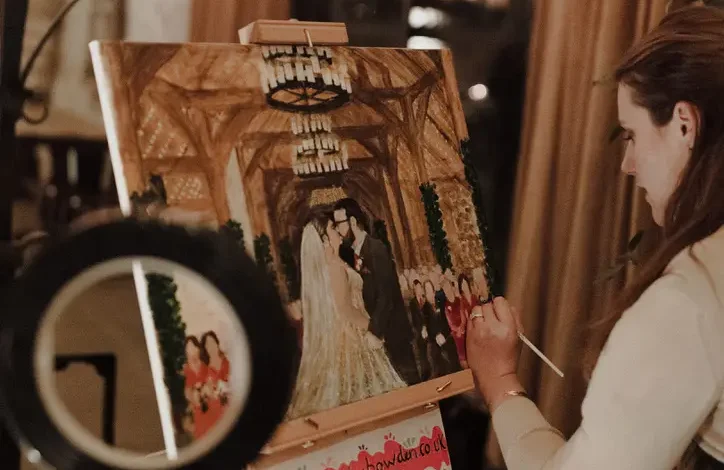 Katie Bowden painting her first live wedding canvas of Phillipa and James