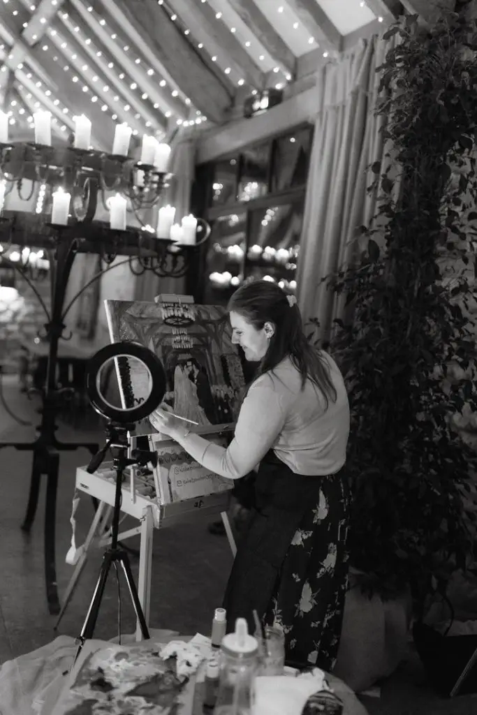 Katie Bowden painting her first live wedding canvas of Phillipa and James black and white