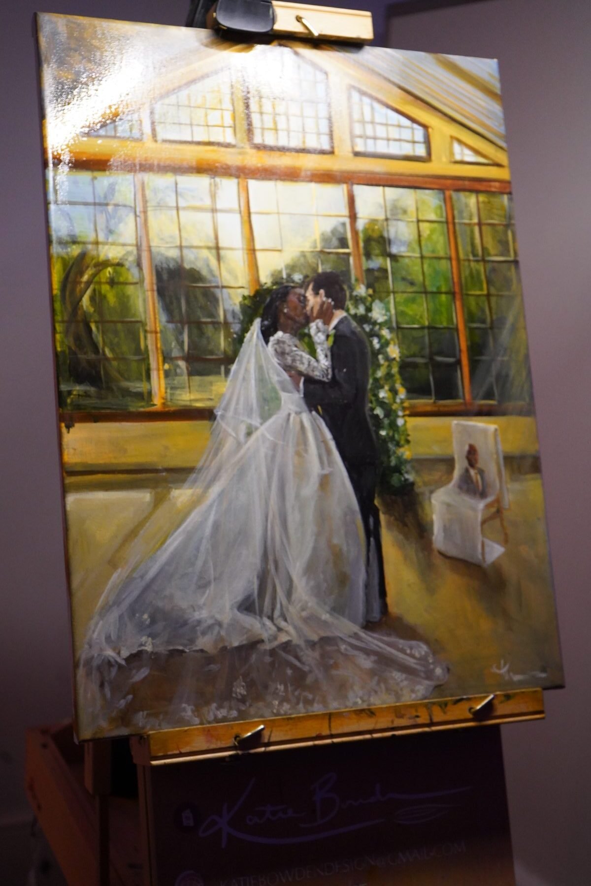 A finished canvas of a couple's first kiss, painted live at their wedding